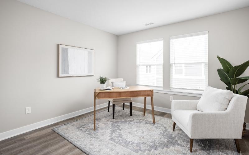 a living room with a table and chairs