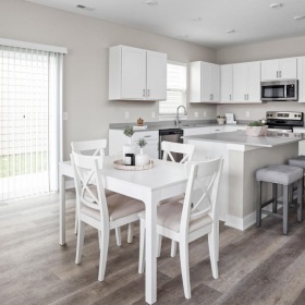 Settle into comfort at Marea a kitchen with a table and chairs